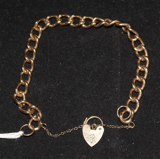 A 9ct gold curblink bracelet with heart shaped clasp.